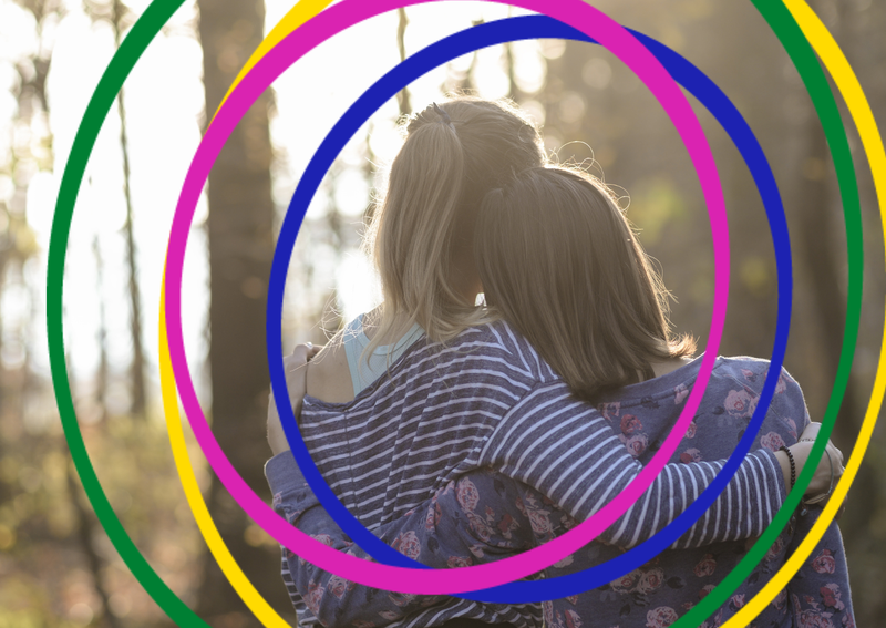 An image of two people showing support through a hug