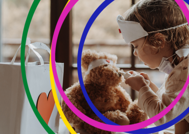 An image of a child role playing as a doctor with the teddy